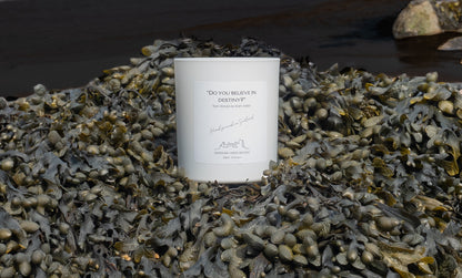 Do you believe in destiny candle with a marine scent and background in Cruden Bay beach