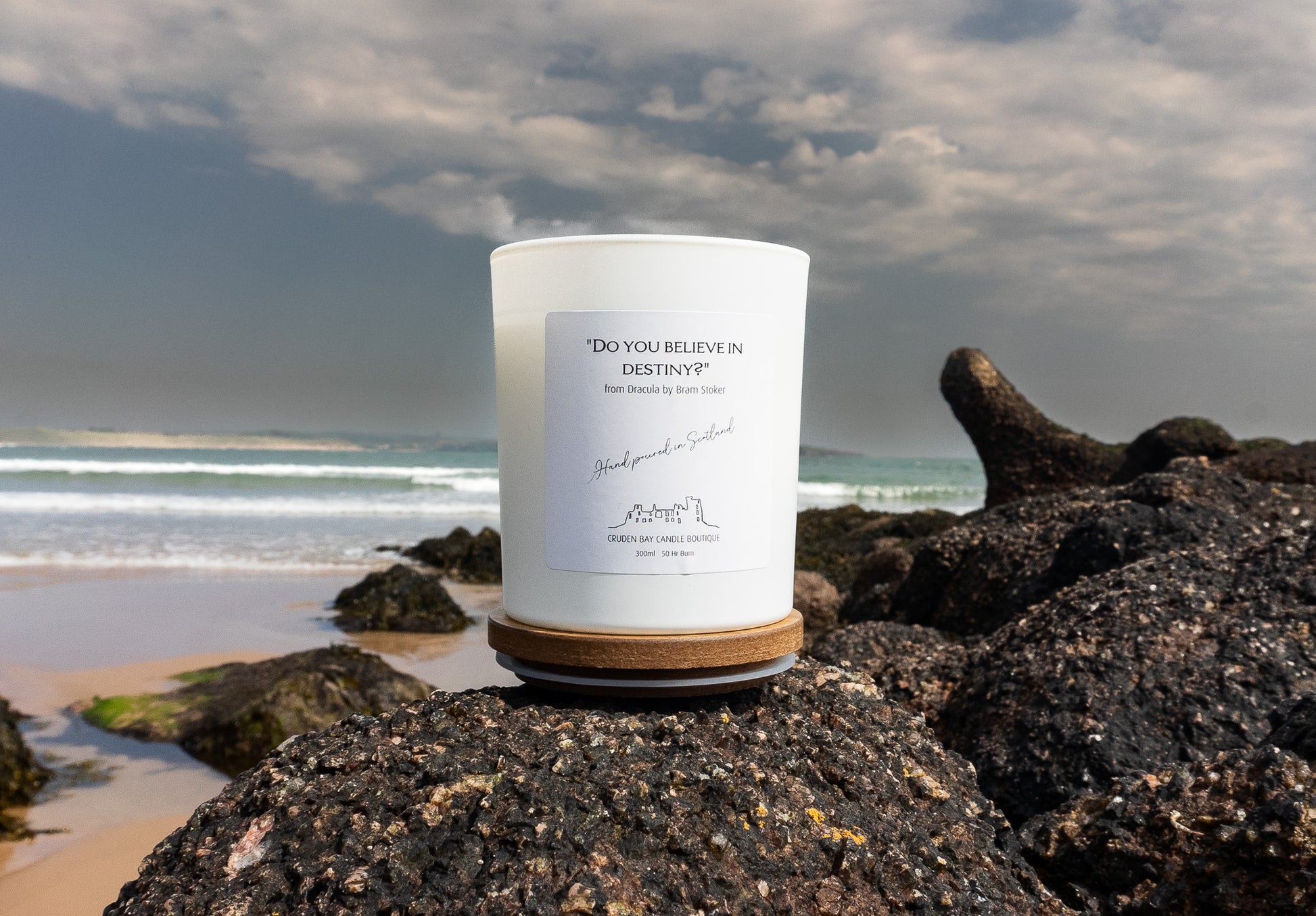 Do you believe in destiny candle with a marine scent and background in Cruden Bay beach