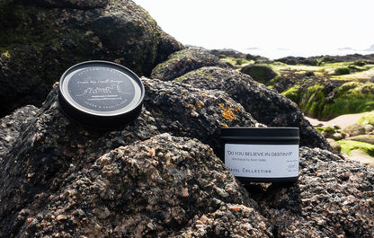 Do you believe in destiny candle with a marine scent and background in Cruden Bay beach